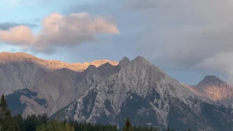 Evergreen trees and rugged mountain peaks in Banff National Park Stock Footage 346879419