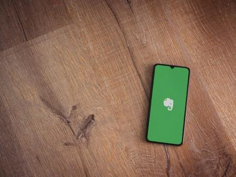 Evernote app launch screen with logo on the display of a black mobile smartph Stock Photos