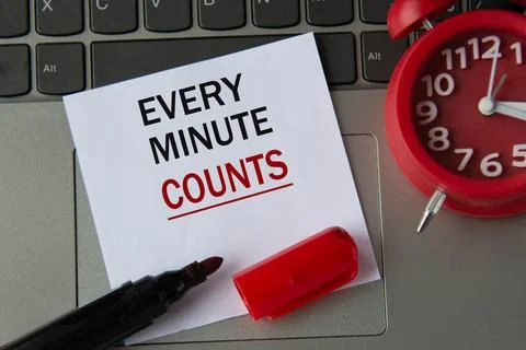 EVERY MINUTE COUNTS on a white sheet against the background of the computer.. Stock Photos