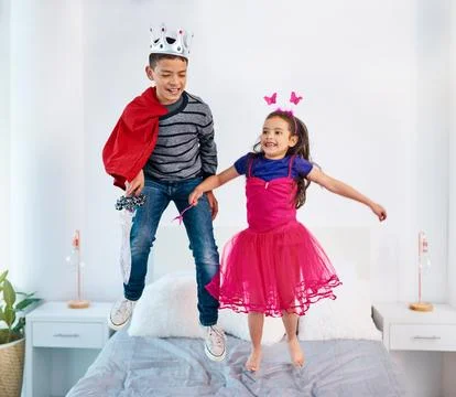 Every superhero learns how to fly eventually. two young children dressed up as Fotos Stock