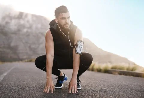 Every workout makes a difference. a sporty young man exercising outdoors. Stock Photos