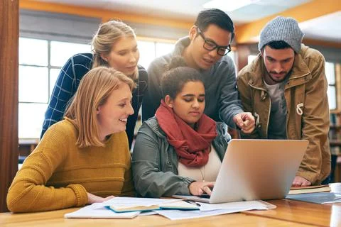Everyone trying to solve a problem together. a cheerful young group of students 스톡 사진