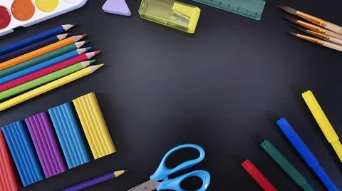 Everything for creativity, various stationery on a black background of a chalk Stock Photos