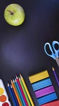 Everything for creativity, various stationery on a black background of a chalk Stock Photos
