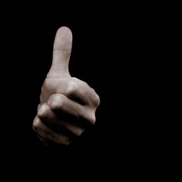 Everything is going to be ok - human hand on black background showing symbol  Stock Photos