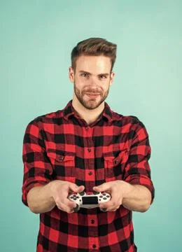 Everything is so real. young man hold game controller to play video games. relax Stock Photos