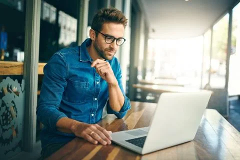 Everything is starting to shape up nicely. a handsome young businessman sitting Stock Photos