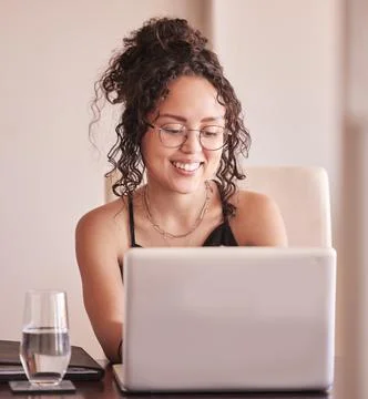 Everything sure is simpler with the help of the internet. a young woman sitting Stock Photos