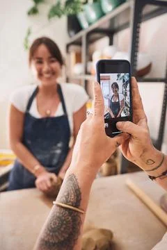 Everything we make has a memory attached to it. a woman using a smartphone to Stock Photos