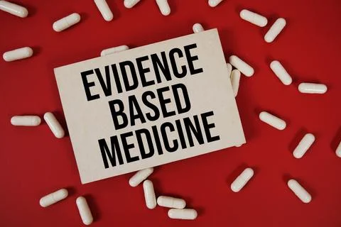 Evidence Based Medicine (EBM) text written on paper card with medicine caps.. Stock Photos
