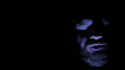 Evil and angry bald man speaking in darkness. 4K UHD Stock Footage 73676799