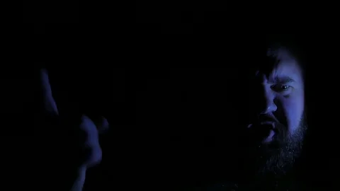 Evil and angry bald man speaking in darkness. 4K UHD 動画素材 73677705