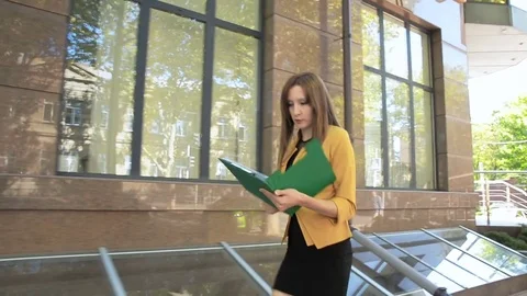 Evil business lady throws out important documents from folder on street Stock Footage 83787316