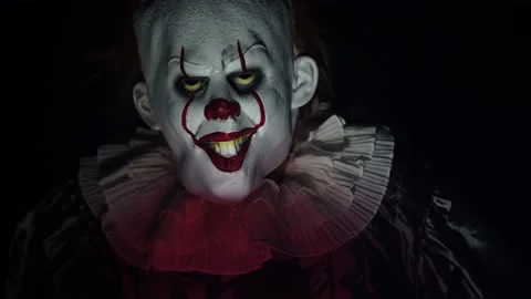 Evil Clown in Dark Scary Halloween Horror Scene, Frightening with Balloon Stock Footage