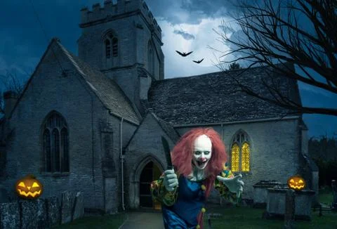 Evil clown with a knife in front of an old church Stock Photos