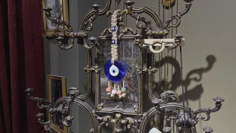 Evil Eye Amulet Hanging on Ornate Metal Candelabra Stock Footage 346041456
