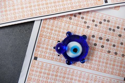 Evil eye bead and optical exam paper, exam and luck, Stock Photos