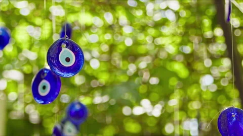 Evil eye beads hanging on branches for decoration purposes Stock Footage 280183756