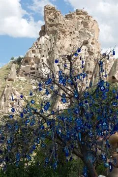 Evil eye in tree behind uchisar castle in cappadocia, Stock Photos