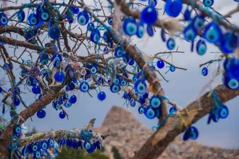 Evil eye in tree behind Uchisar Castle in Cappadocia, Uchisar, Turkey. Stock Photos