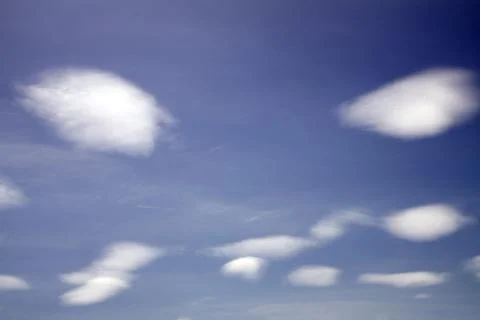 Evil face from the clouds to the sky . Stock Photos