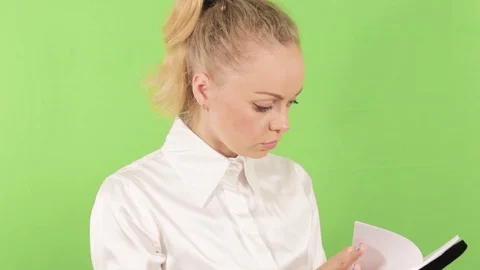 Evil girl looking for a document Stock Footage 78363997