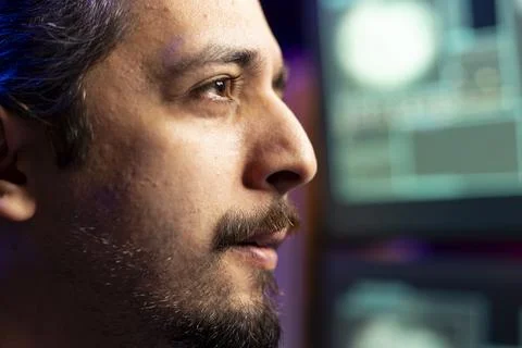 Evil man in cyber safehouse exploiting servers for stolen data profit, close up 스톡 사진