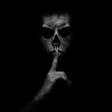 Evil man gesturing silence, quiet isolated on black background Stock Photos