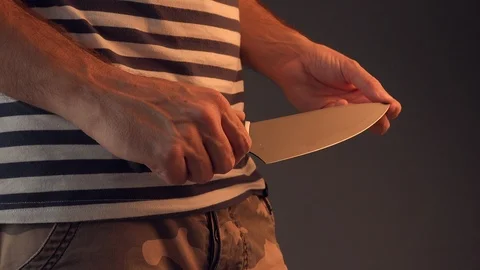Evil man hold shiny knife Video stock 97702425