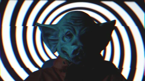 Evil man with pig mask sitting on chair with hypnotic black spiral behind Stock Footage 220927187
