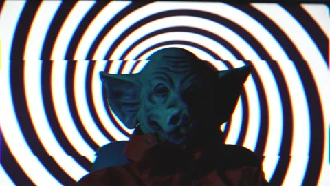 Evil man with pig mask turning on chair with psychadelic rotating spiral Stock Footage 221822306