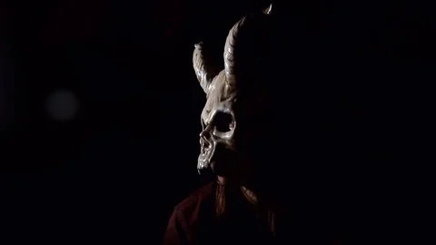 Evil Mask turns towards camera Stock Footage 79667565