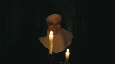 Evil nun walking with burning candles in chambers of haunted monastery, horror Stock Footage 257006065