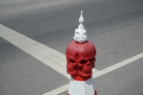 Evil red skull shape road parking cone traffic sign on the public street in f Stock Photos