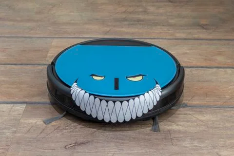 Evil robots concept. Robot vacuum cleaner with evil grin Stock Photos