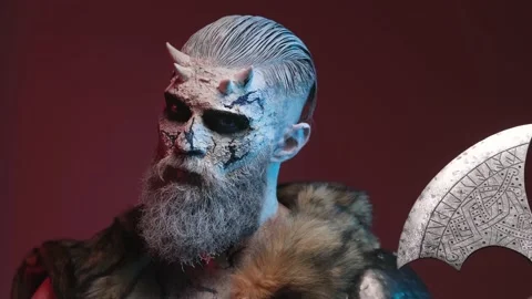 Evil undead warrior with axe and pale skin in dark red background Video stock 146579627