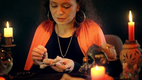 Evil witch using needle to pierce voodoo doll, wishing somebody to get ill Stock-Footage 170816617