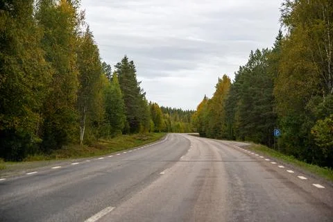 An evocative perspective of a straight, endless asphalt road winding through Stock Photos