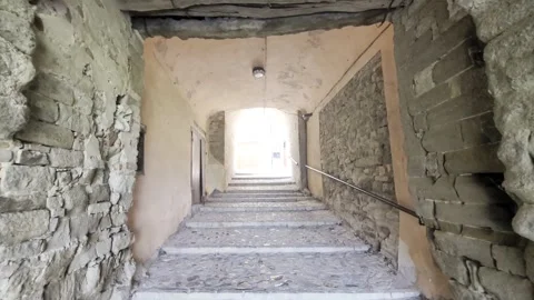 An evocative stone staircase crosses a covered arched passage Stock Footage 343760119