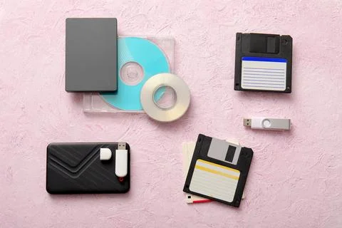 Evolution of data storage devices: floppy disks, cds, external hard drives, a Stock Photos