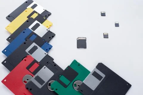 The evolution of digital data storage device. Floppy disks vs memory cards. Stock Photos