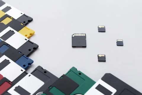 The evolution of digital data storage device. Floppy disks vs memory card. Stock Photos