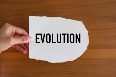 Evolution Evolution. Woman hand holds a piece of paper with a note, evolut... Stock Photos