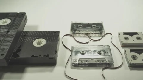 Evolution of memory storage devices, from VHS Tape and Audio Cassette, Film,  Stock Footage 165347945