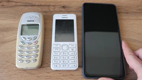 Evolution of mobile phones. Two old phones and a smartphone 動画素材 191141014