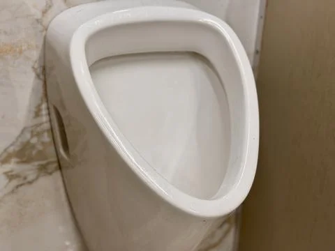 The Evolution of Modern Urinal Designs in Contemporary Public Restroom Spaces Stock Photos