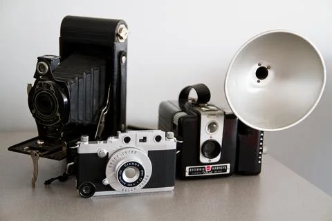 Evolution of Vintage Cameras on Neutral Background Stock Photos