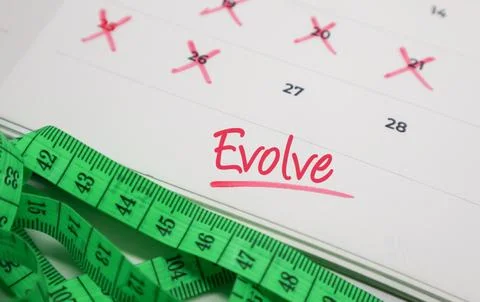 Evolve text on calendar with measuring tape. Concept of personal growth, fi.. Stock Photos