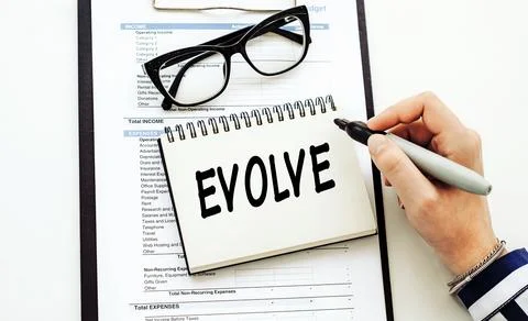 Evolve. text on white notepad on documents 写真素材