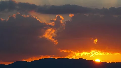 The exact moment sun sets while beautifully illuminating clouds Japan dusk, 01 Stock Footage 340537249
